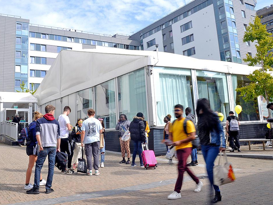 People walking outside the Rolle Marquee on the University of Plymouth campus