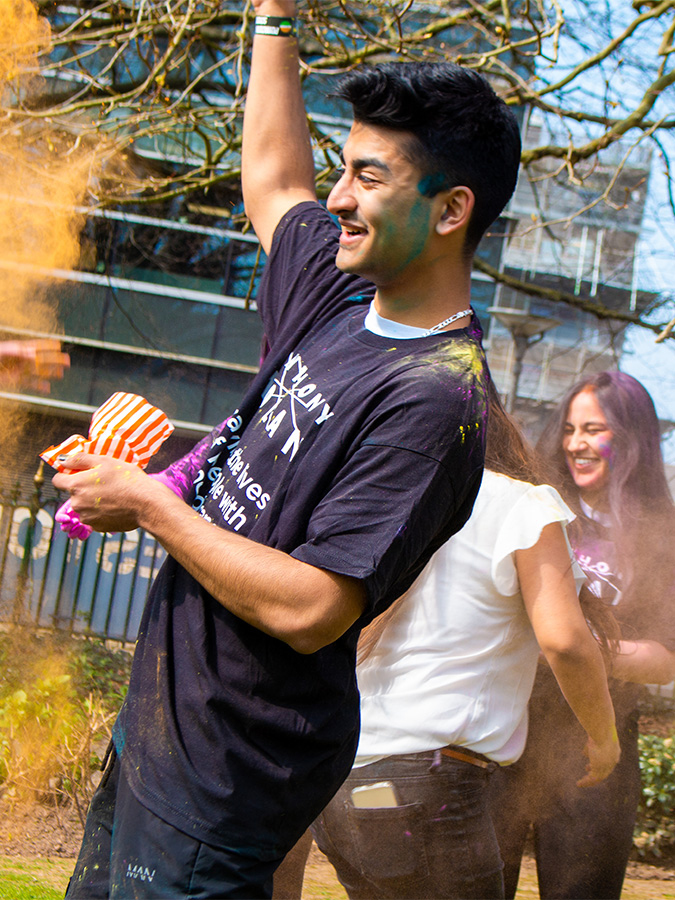 Students celebrating Holi in Drake's Gardens